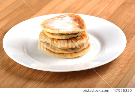 Oat pancakes with powdered sugar on top 47956330