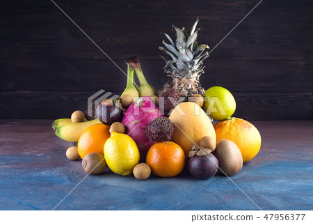 Assorted tropical fruits, orange,Ananas or pineapple, lime,mango, dragon fruit, orange, banan 47956377