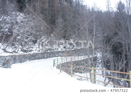 Mountain snowy road in the winter forest. 47957322