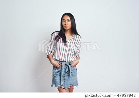 Pure beauty. Beautiful asian young woman in casual wear looking at camera and keeping hands in 47957948