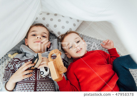 Two funny boys play together. Cute happy brothers smiling and having fun 47958378