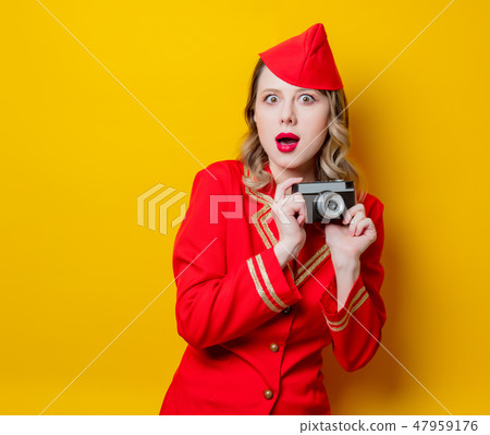 stewardess wearing in red uniform with photo camera stewardess wearing in red uniform with photo camera 47959176