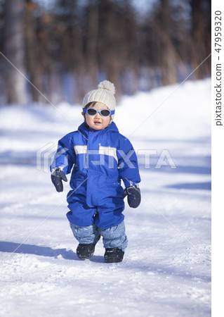 Boy playing in the snow Boy playing in the snow 47959320