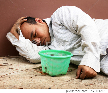 Homeless man sleeping and sadness on street. Homeless man sleeping and sadness on street. 47964715