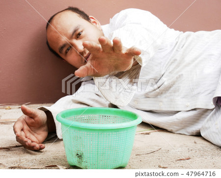 Homeless man sleeping and sadness on street. Homeless man sleeping and sadness on street. 47964716