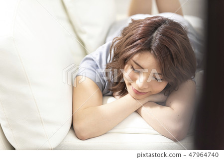 Young lady sofa relaxing cheek lifestyle Young lady sofa relaxing cheek lifestyle 47964740