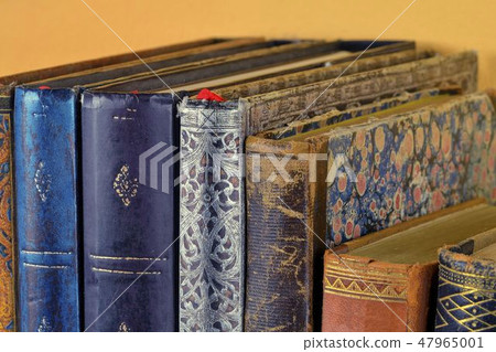 Cultural heritage. Old books on wooden shelf. Antique books on yellow background. Close up Cultural heritage. Old books on wooden shelf. Antique books on yellow background. Close up 47965001