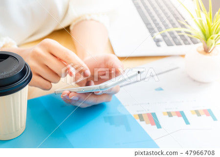 Hand of a woman holding a smartphone 47966708