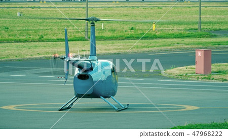 Small blue helicopter ready for take off from the airport Small blue helicopter ready for take off from the airport 47968222