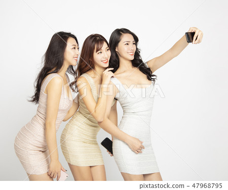 three young beauty taking selfie with smartphone three young beauty taking selfie with smartphone 47968795