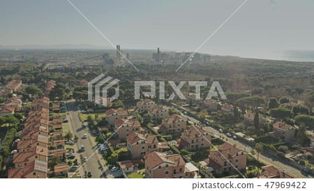 Aerial view of a residential area against air polluting plant Aerial view of a residential area against air polluting plant 47969422