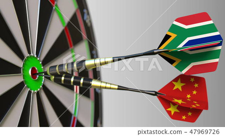 Flags of South Africa and China on darts hitting bullseye of the target. International cooperation 47969726