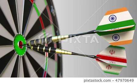 Flags of India and Iran on darts hitting bullseye of the target. International cooperation or 47970649