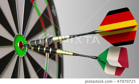 Flags of Germany and Italy on darts hitting bullseye of the target. International cooperation or 47970725