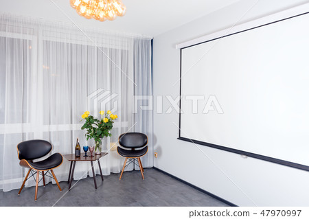 Modern studio interior with lights on. Projector screen. Contemporary interior with loft elements. 47970997