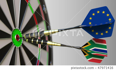 Flags of the European Union and South Africa on darts hitting bullseye of the target. International 47971416