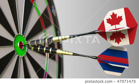 Flags of Canada and Russia on darts hitting bullseye of the target. International cooperation or 47971478