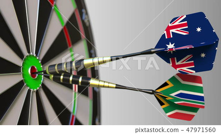Flags of Australia and South Africa on darts hitting bullseye of the target. International 47971560