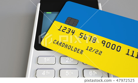 Payment terminal with credit card featuring flag of Ukraine. Ukrainian national banking system Payment terminal with credit card featuring flag of Ukraine. Ukrainian national banking system 47972525