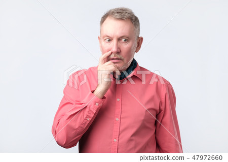 Senior guy wearing red shirt wondering and thinking about problems Senior guy wearing red shirt wondering and thinking about problems 47972660