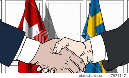 Businessmen or politicians shake hands against flags of Switzerland and Sweden. Official meeting or Businessmen or politicians shake hands against flags of Switzerland and Sweden. Official meeting or 47974147