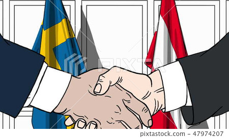 Businessmen or politicians shake hands against flags of Sweden and Austria. Official meeting or 47974207