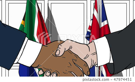 Businessmen or politicians shake hands against flags of South Africa and Britain. Official meeting 47974451