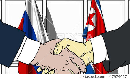 Businessmen or politicians shake hands against flags of Russia and North Korea. Official meeting or Businessmen or politicians shake hands against flags of Russia and North Korea. Official meeting or 47974627