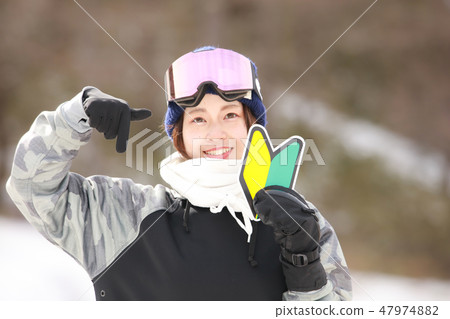 A woman with a snowboard wear with a beginner's mark 47974882