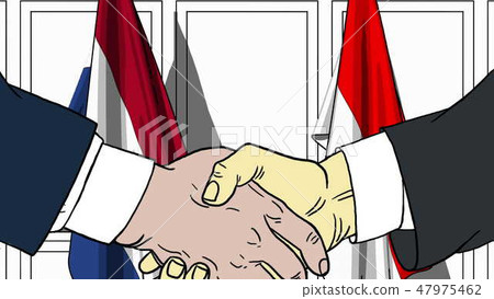 Businessmen or politicians shaking hands against flags of Netherlands and Indonesia. Meeting or Businessmen or politicians shaking hands against flags of Netherlands and Indonesia. Meeting or 47975462