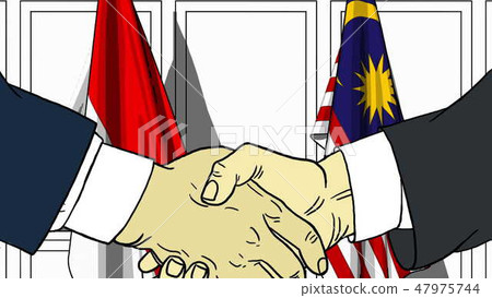 Businessmen or politicians shake hands against flags of Indonesia and Malaysia. Official meeting or Businessmen or politicians shake hands against flags of Indonesia and Malaysia. Official meeting or 47975744