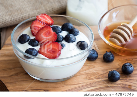 Yogurt with strawberries and blueberries 47975749