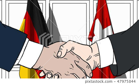 Businessmen or politicians shaking hands against flags of Germany and Switzerland. Meeting or Businessmen or politicians shaking hands against flags of Germany and Switzerland. Meeting or 47975844
