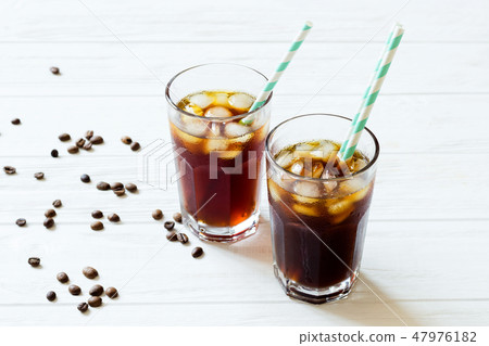 Coffee with ice. Cold brew on white wooden table Coffee with ice. Cold brew on white wooden table 47976182