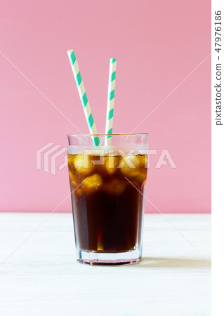 Cold brew. Coffee with ice and striped straws Cold brew. Coffee with ice and striped straws 47976186