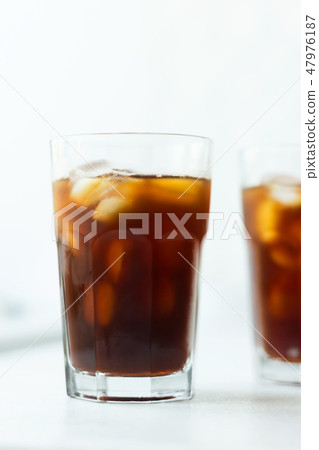 Cold brew. Coffee with ice on light background Cold brew. Coffee with ice on light background 47976187