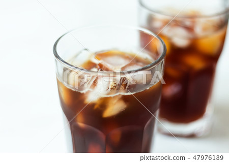 Coffee with ice on light background. Cold brew Coffee with ice on light background. Cold brew 47976189