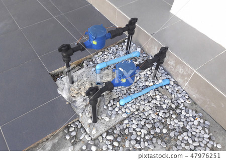 Water pipe and meter with waterspout on floor. 47976251