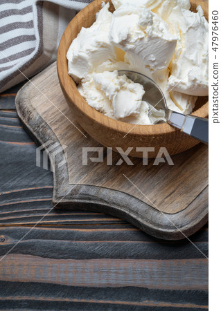 Traditional Mascarpone cheese in wooden bowl on table 47976460