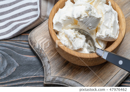 Traditional Mascarpone cheese in wooden bowl on table 47976462