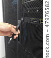 Man open the door of computer server rack 47976582
