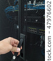 Man open the door of computer server rack 47976602