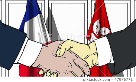 Businessmen or politicians shake hands against flags of France and Hong Kong. Official meeting or 47976771