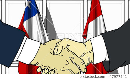 Businessmen or politicians shake hands against flags of Chile and Peru. Official meeting or 47977341