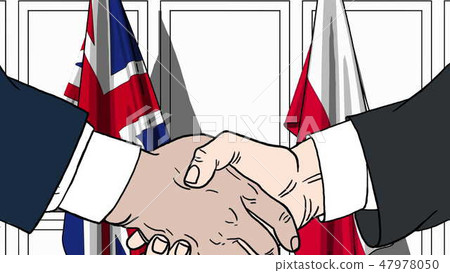 Businessmen or politicians shake hands against flags of Britain and Poland. Official meeting or 47978050