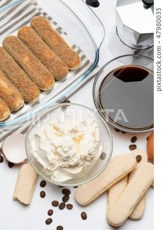 Ingredients for making traditional italian cake tiramisu on white background Ingredients for making traditional italian cake tiramisu on white background 47980035