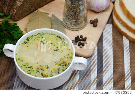Mushroom soup with croutons in a white dish. Mushroom soup with croutons in a white dish. 47980592