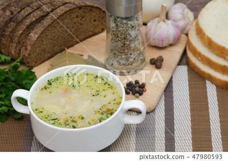 Mushroom soup with croutons in a white dish. Mushroom soup with croutons in a white dish. 47980593