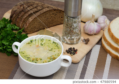 Mushroom soup with croutons in a white dish. Mushroom soup with croutons in a white dish. 47980594