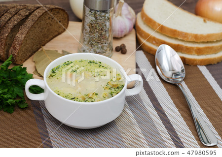 Mushroom soup with croutons in a white dish. Mushroom soup with croutons in a white dish. 47980595